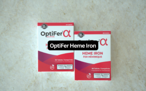OptiFer Heme Iron banner showing two OptiFer Alpha 90-tablet boxes flat on a marble counter