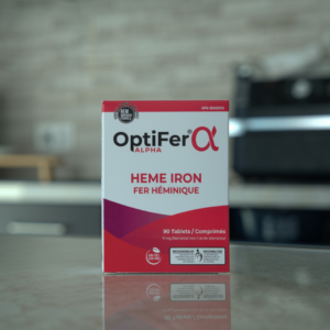 OptiFer Alpha organic iron supplements box with 90 heme iron tablets on a kitchen counter